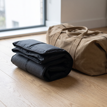 Vaebo Pro Boots rolled flat next to a travel bag